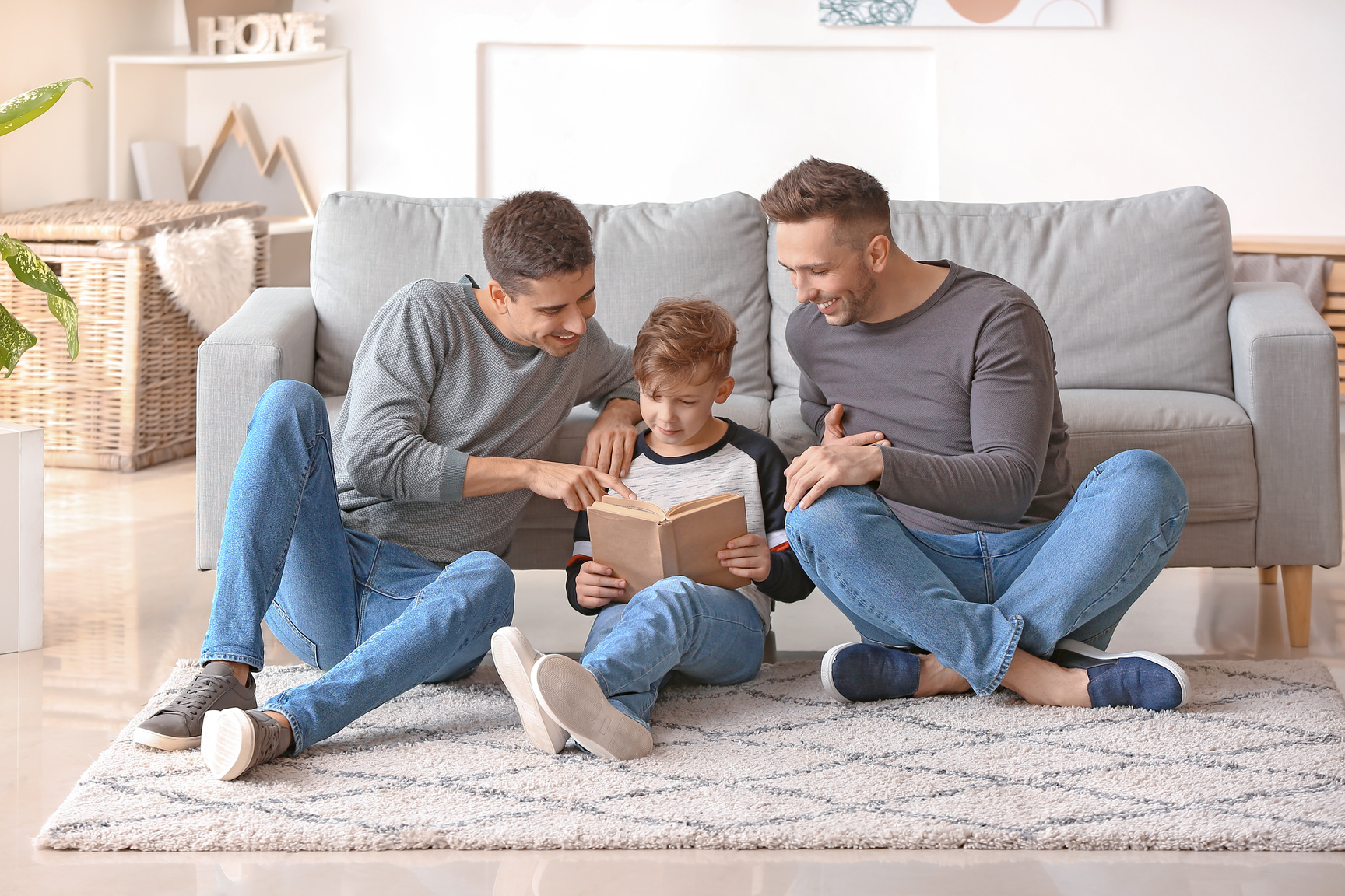 Gay Men Reading a Book with Their Son 